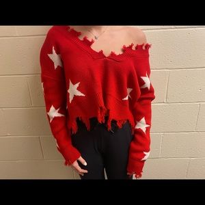Women’s off the shoulder star sweater.